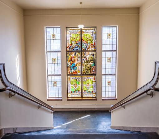 A stained glass window with a lot of colors and designs.