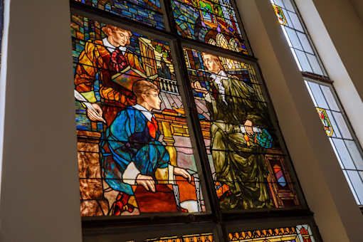 A stained glass window depicting a group of people.