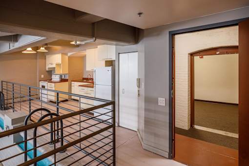 A kitchen with a white fridge and a white door.