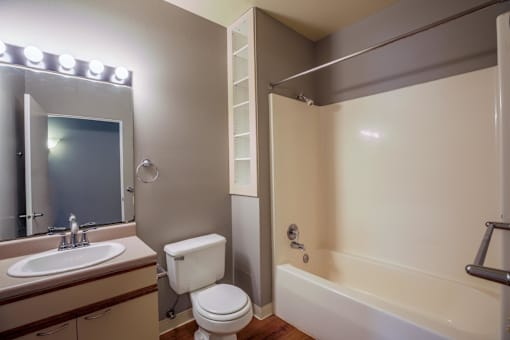 A bathroom with a toilet, sink, and bathtub.