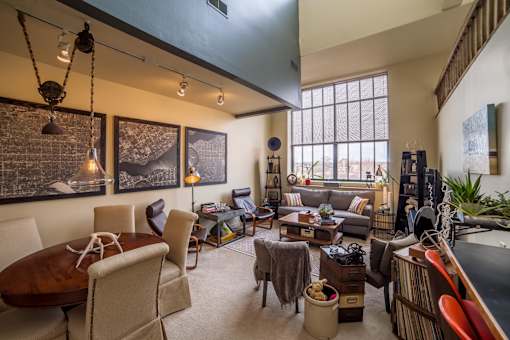 A living room with a couch, chairs, and a coffee table.