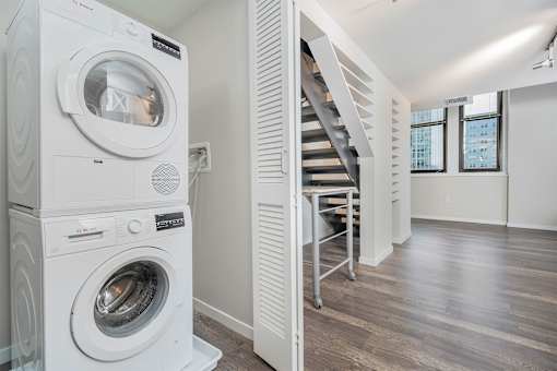 A white washing machine and dryer in a laundry room.