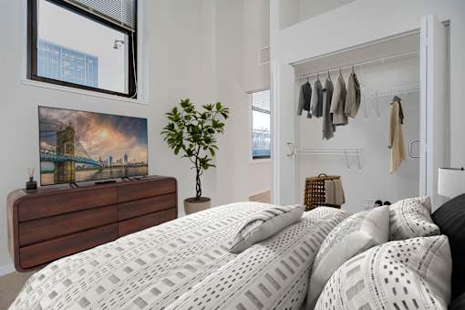 A bedroom with a large bed and a painting on the wall.