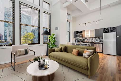 A modern living room with a green sofa and a coffee table.