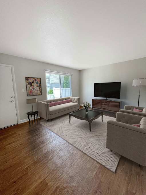 A living room with a couch, chair, and coffee table.