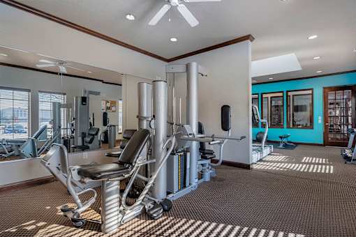 A gym with a variety of equipment including a leg press machine.