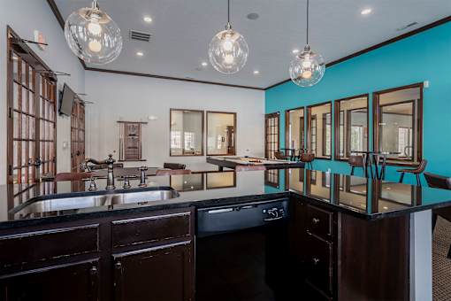A kitchen with dark wood cabinets and a black countertop.
