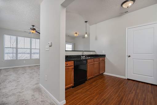 A kitchen with wooden cabinets and a black countertop.