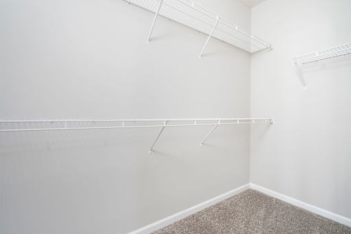 Empty room with white walls and carpeted floor.