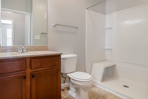 A white toilet sits next to a sink in a bathroom.