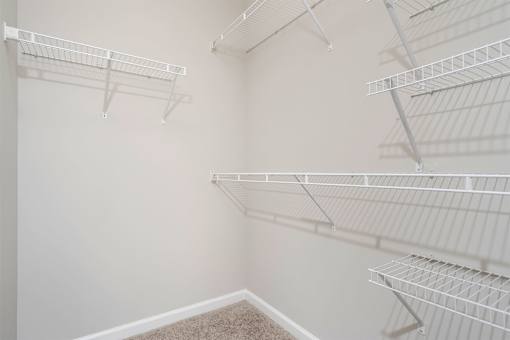 Empty white shelves in a room.