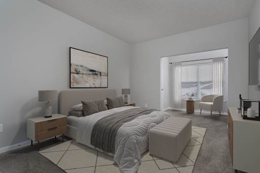 A bedroom with a large bed and a painting on the wall.