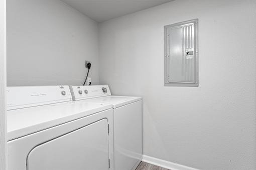 A white washing machine and dryer in a small laundry room.