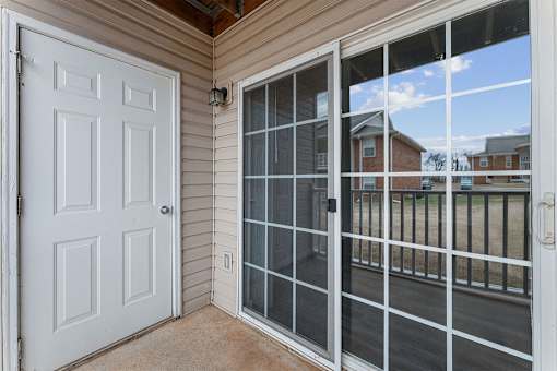 A white door is on the left and a glass door is on the right.