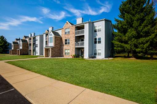 Apartment buildings with green lawns in front.