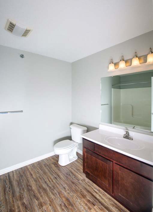 A white toilet sits next to a sink in a bathroom.