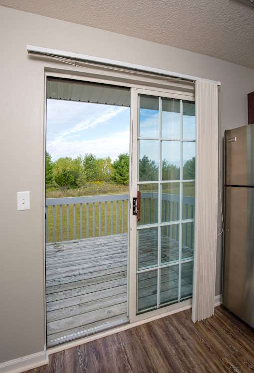 A glass door with a handle is open.