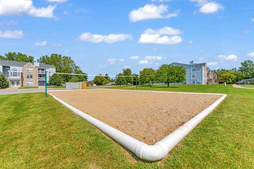 A large white pipe runs through a grassy field.