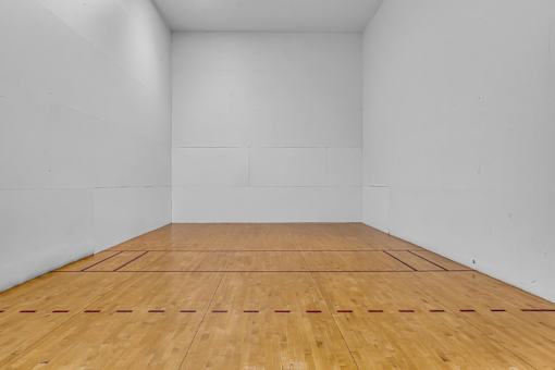 A wooden floor with white walls and a white ceiling.