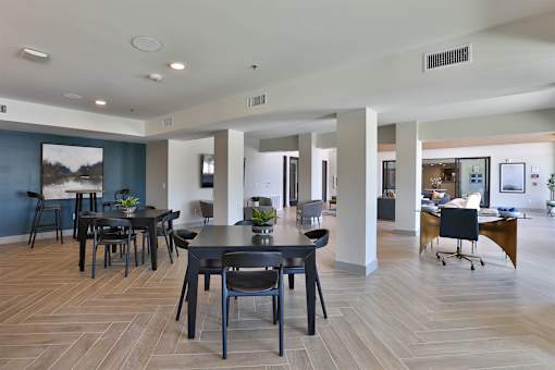 A spacious room with a dining table and chairs.
