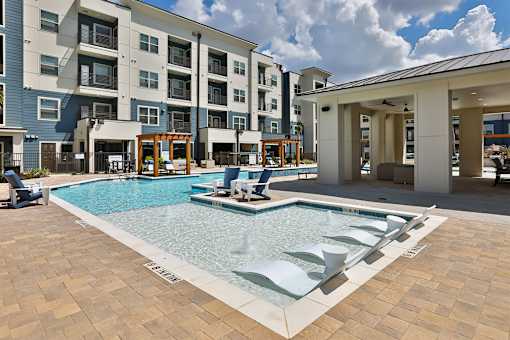 A large swimming pool in front of a building.