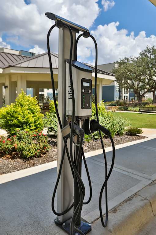 A Bilt car charging station is on the sidewalk.