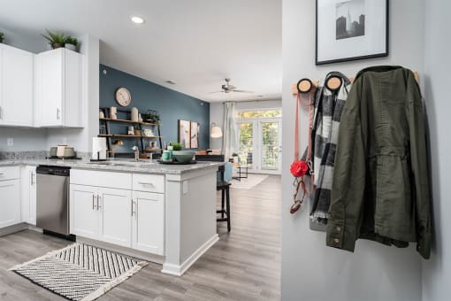 a kitchen and a living room with a counter top