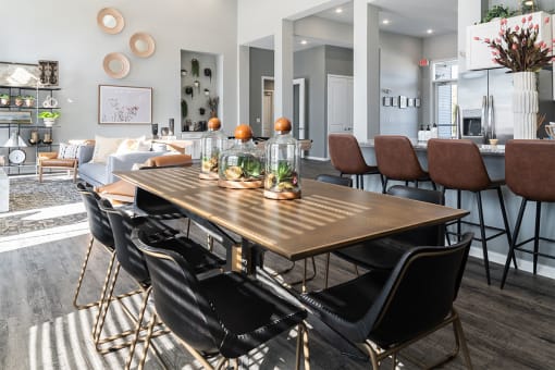 a dining room and living room with a table and chairs
