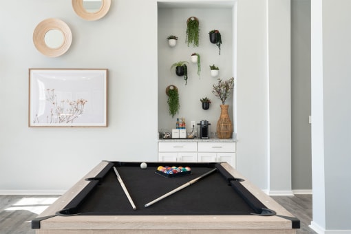a pool table in the living room of a home
