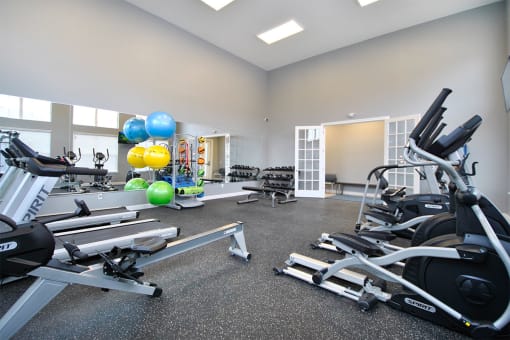 a gym with weights and other exercise equipment and balloons