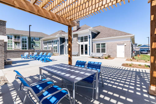 our apartments have a large patio with chairs and tables