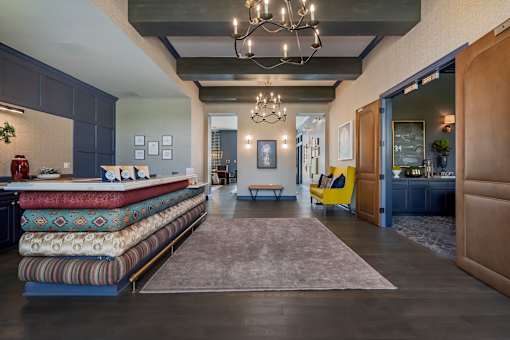 A modern living room with a long sofa and a chandelier.