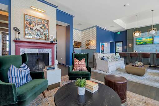 A living room with a fireplace and a painting on the wall.