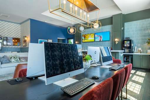 A modern home office with a large desk and a computer setup.