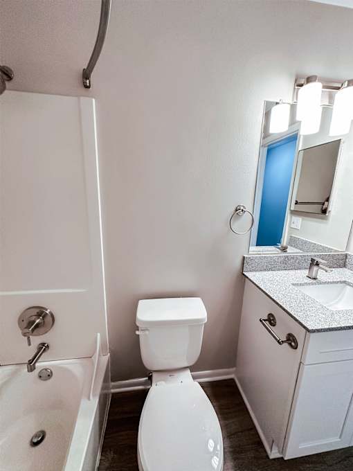 A white toilet sits next to a sink in a bathroom.