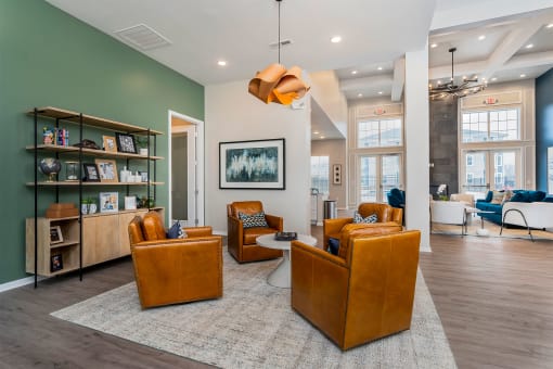 clubhouse with brown leather chairs and shelves