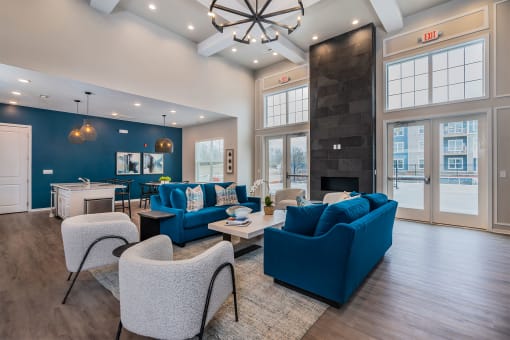 clubhouse with large windows blue sofas and gray chairs