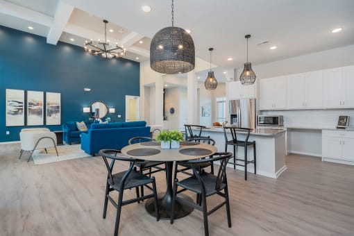 clubhouse with community kitchen dining table and blue sofa