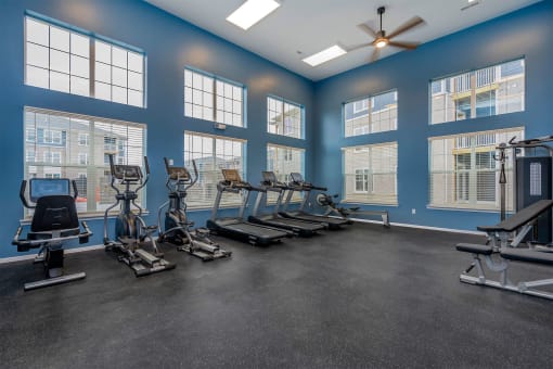 fitness center with elliptical machines and treadmills