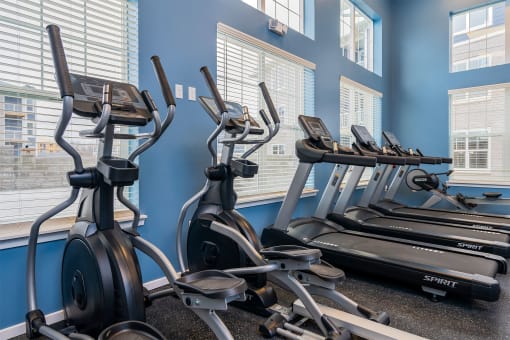 fitness center with elliptical machines and treadmills