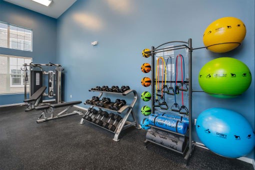 fitness center with dumbbells and yoga equipment