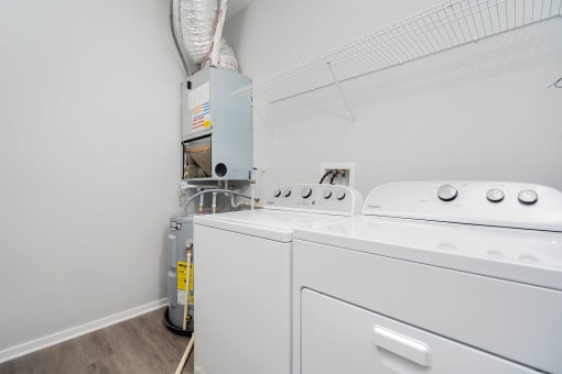 a washer and dryer in a room with a white wall
