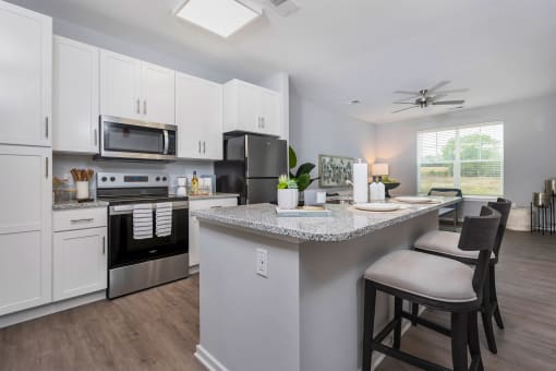 a kitchen with an island and a stove and a microwave