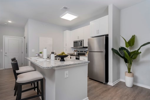 a kitchen with a counter top and a stainless steel refrigerator