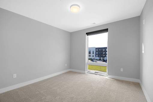 A room with a window showing a cityscape outside.