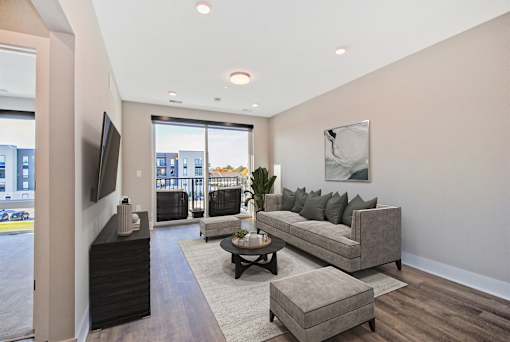 A living room with a grey couch and a coffee table.