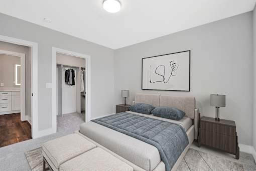 A bedroom with a large bed and a painting on the wall.