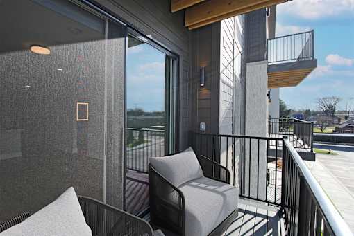 A balcony with a chair and a table.