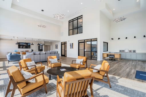 a large living room with chairs and a couch