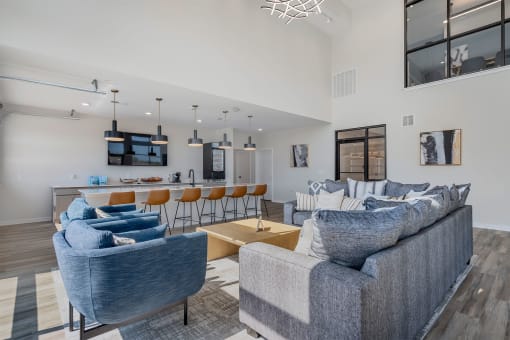 a living room with a couch and a kitchen with a bar